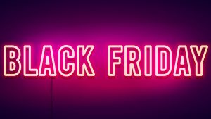 A glowing neon Black Friday sign with a dark background