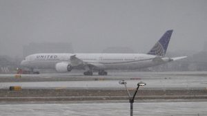 A jet taxis in snow at O'Hare International Airport on December 22, 2022 in Chicago, Illinois.