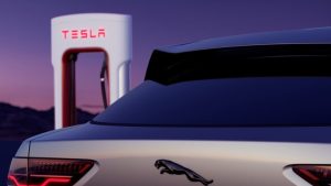 Jaguar EV with a Tesla Supercharger in the background