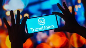 In this photo illustration, the TransUnion logo is displayed on a smartphone screen.